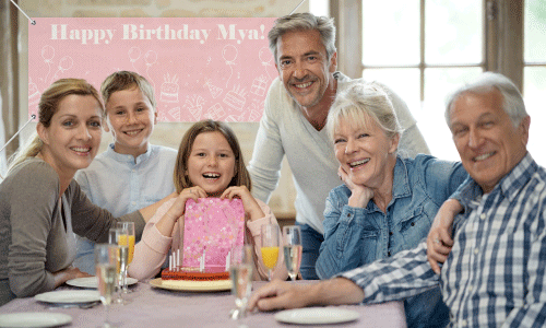 Pink birthday banner with family gathered around a brunette little girl